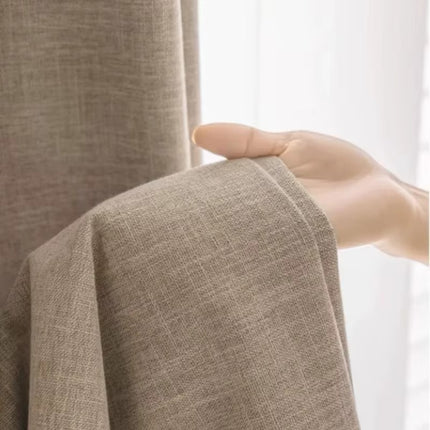 a person holding a curtain with their hand