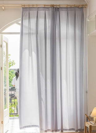 a living room with a large window and curtains
