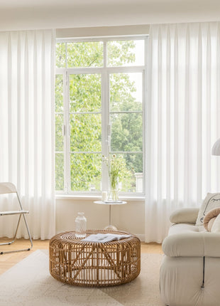 a living room with a couch, chair, table and window
