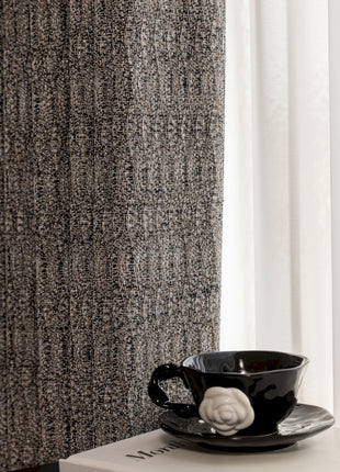 a black coffee cup sitting on top of a white box