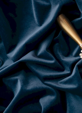 a close up of a piece of jewelry on a blue cloth