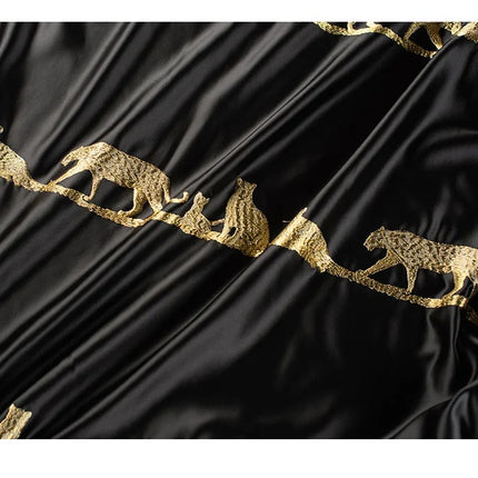 a black and gold fabric with animals on it