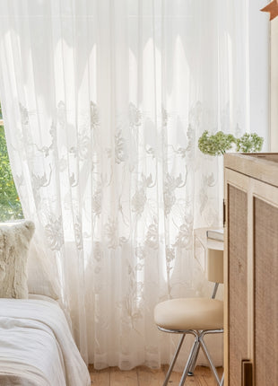 a bedroom with a bed, dresser and window