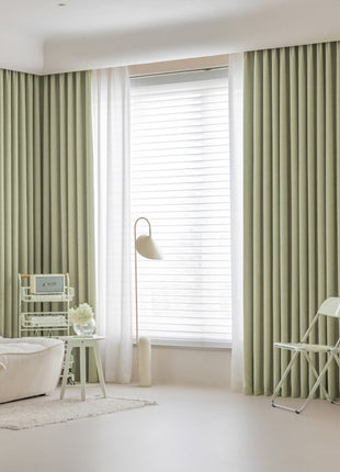 a living room with a white couch and a chair