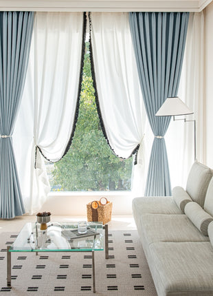 a living room filled with furniture and a large window