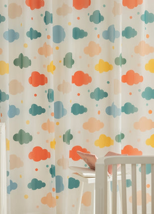 a baby's room with a crib, dresser, and curtain