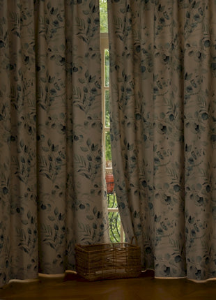 a living room with a large window covered in curtains