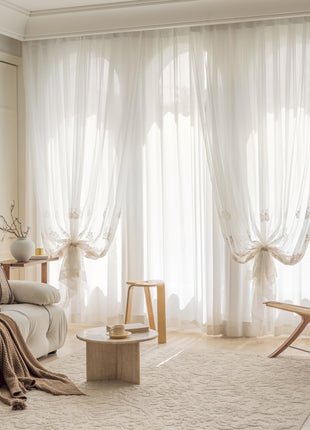 a living room with a white couch and a chair