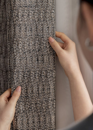 a woman is placing a piece of carpet on a wall