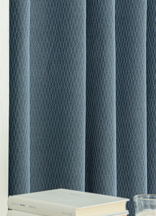 a glass of water and a book on a table