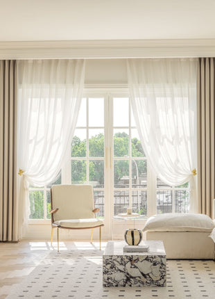 a living room filled with furniture and a large window