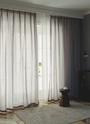 a living room with a large window and a rug