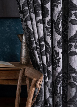 a chair sitting next to a table with a book on top of it