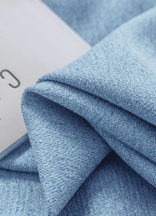 a close up of a blue blanket with a label on it