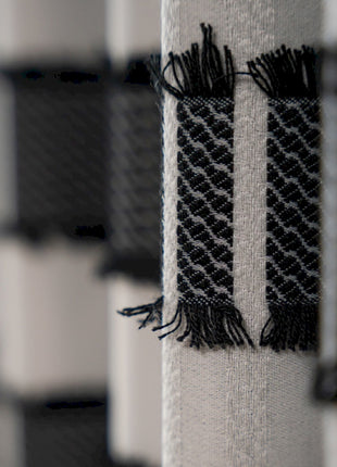a row of black and white curtains with fringes