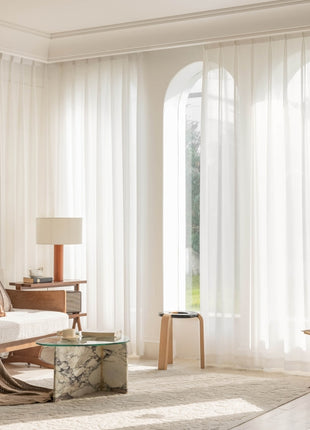 a living room filled with furniture and a large window