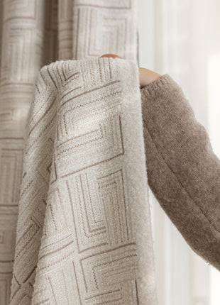 a woman is holding up a blanket in front of a window