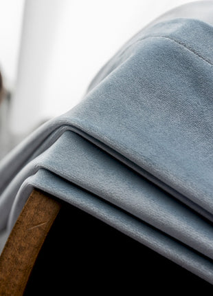 a stack of folded blue sheets on top of a table