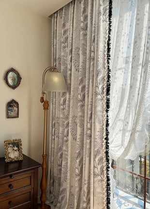 a window with a curtain and a lamp next to it