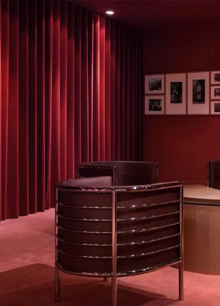 a room with red curtains and a table and chairs