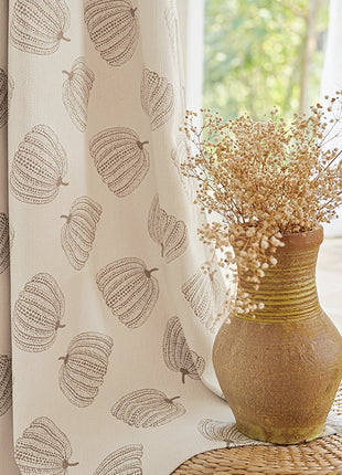 a vase filled with dried flowers sitting on top of a table