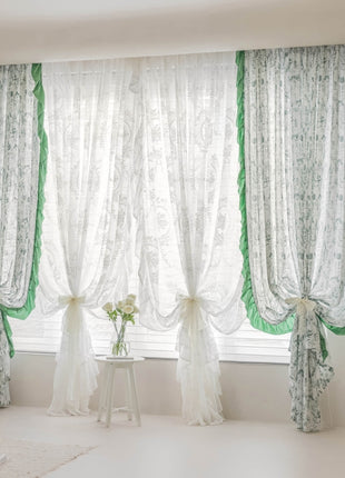 a living room with a white couch and green curtains