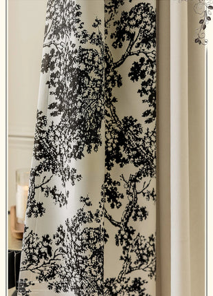 a curtain with a black and white tree design