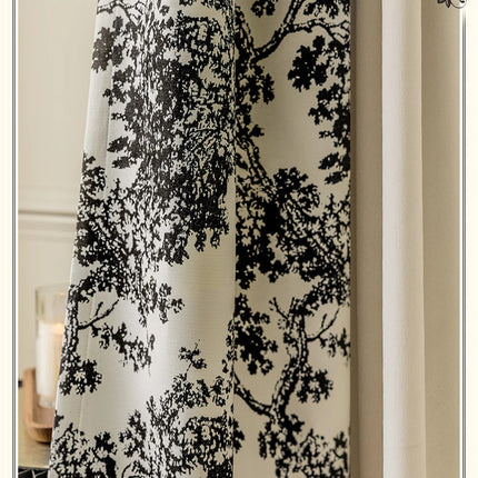 a curtain with a black and white tree design