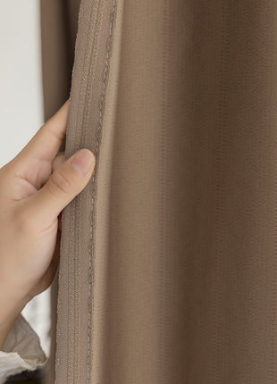 a person's hand is peeking through a curtain