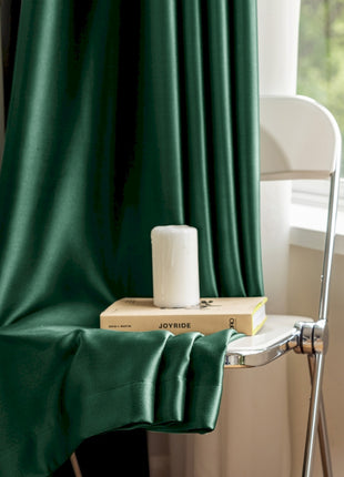 a stack of books sitting on top of a chair next to a window