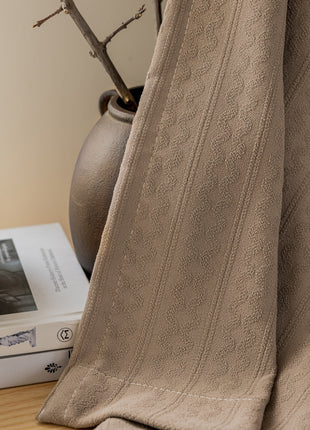 a book sitting on top of a table next to a vase