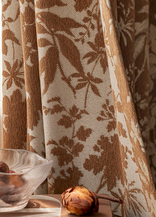 a bowl of nuts sitting on a table next to a window