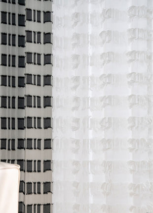 a white chair sitting in front of a window