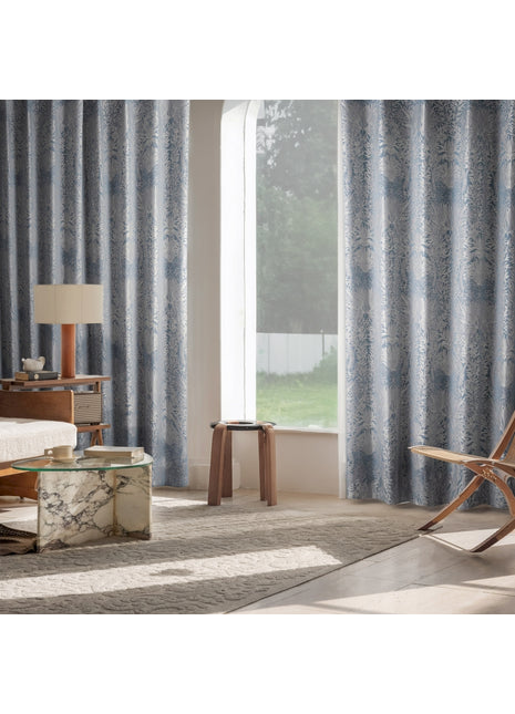 a living room with a chair and a window