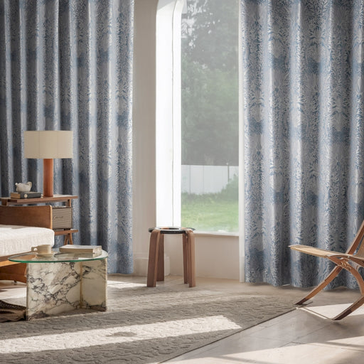 a living room with a chair and a window