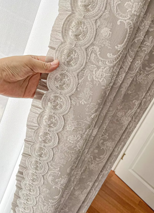 a person holding a curtain in their hand
