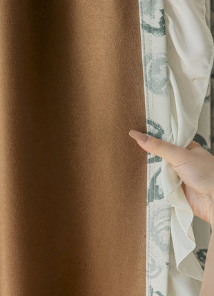 a person's hand is peeking out of a curtain