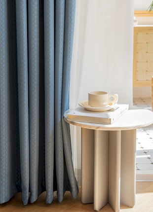 a table with a cup on top of it next to a window