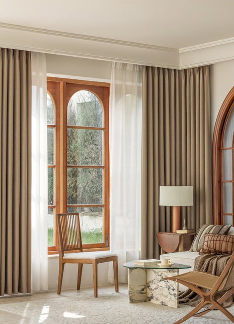 a living room filled with furniture and a large window