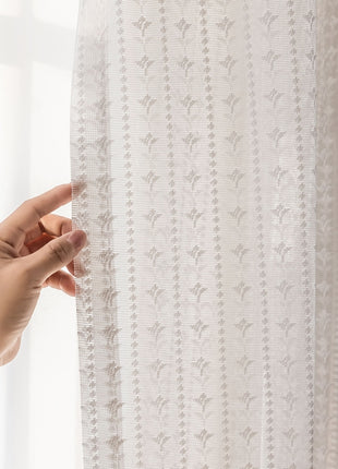 a person is holding a curtain with their hand