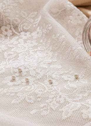 a glass jar filled with flowers sitting on top of a table