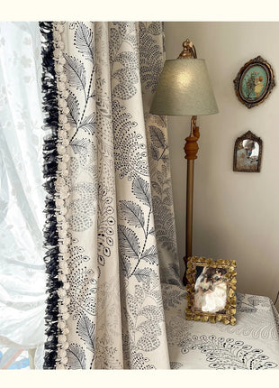 a lamp sitting on top of a table next to a window