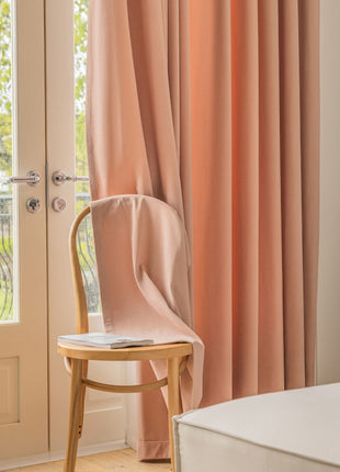 a chair sitting in front of a window next to a bed