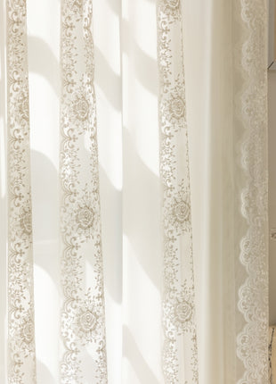 a window with a white curtain and a potted plant