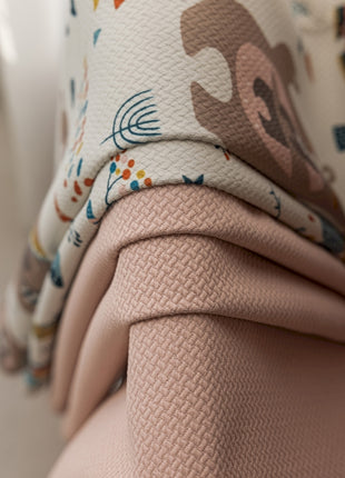 a close up of a pink purse with a flower pattern