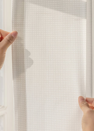 two hands are reaching up to a white curtain