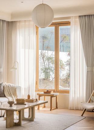 a living room filled with furniture and a large window