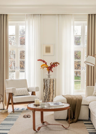 a living room filled with furniture and a large window