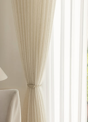 a living room with a white couch and a lamp