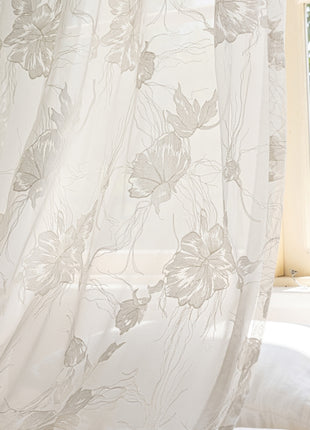 a window with a white curtain and a white pillow